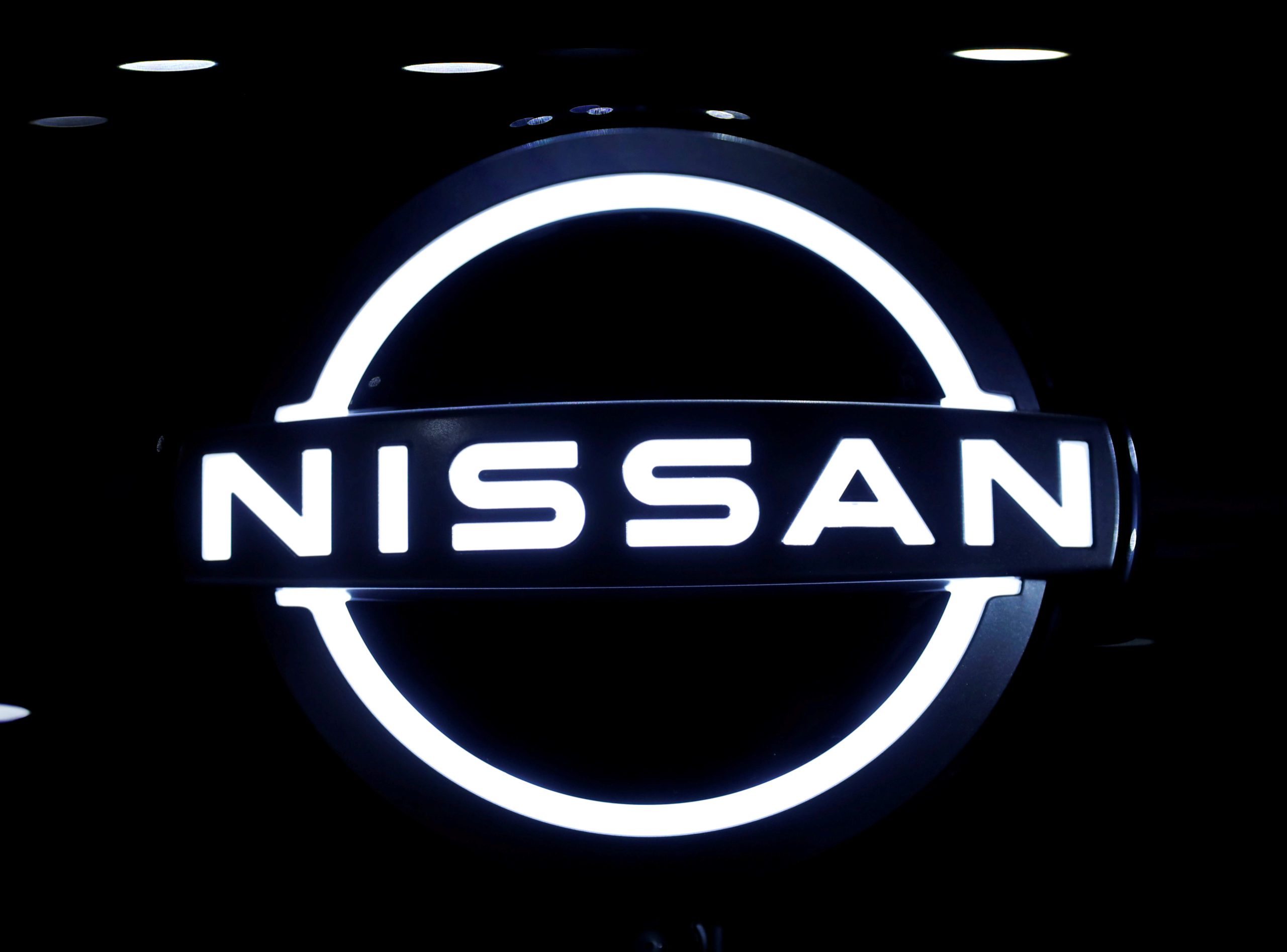 FILE PHOTO: The brand logo of Nissan Motor Corp. is seen at the front nose section of the company's new Ariya all-battery SUV during a press preview, ahead of the world premiere, at Nissan Pavilion in Yokohama, south of Tokyo, Japan July 14, 2020. REUTERS/Issei Kato/File Photo - RC2BUH9OXA8P