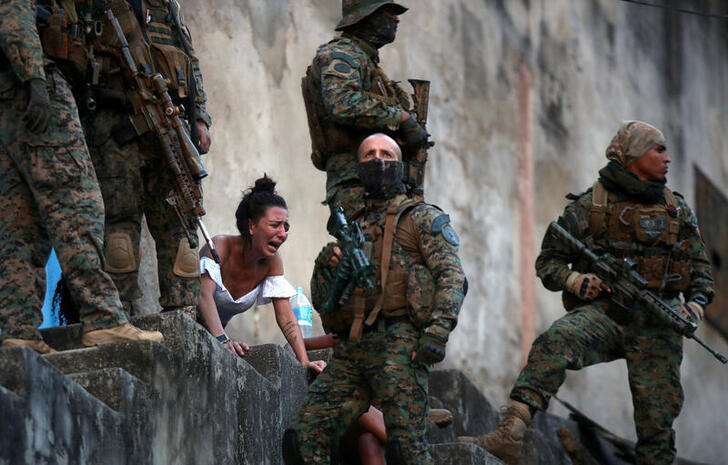 Juliana, who says she is four months pregnant, reacts in front of the body of her husband Davi Barboza, who was shot in Sao Carlos, during a police operation after heavy confrontations between drug gangs, in Rio de Janeiro, Brazil, August 27, 2020. 