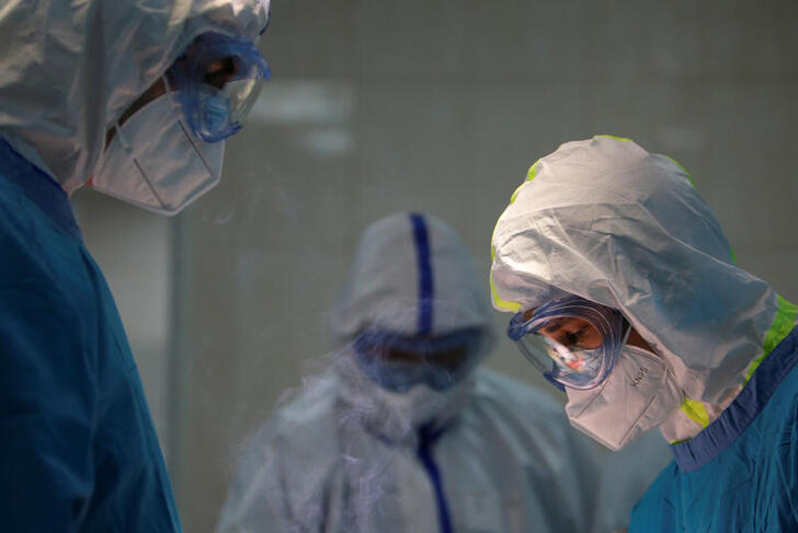 Doctor Islam Muradov (L) performs emergency surgery in the operating room of the City Clinical Hospital Number 15 named after O. Filatov, which delivers treatment to patients infected with the coronavirus disease (COVID-19), in Moscow, Russia May 25, 2020. Picture taken May 25, 2020. REUTERS/Maxim Shemetov