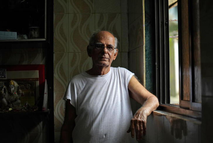 Kishan Lal, 82, poses for a photograph inside his house in Mumbai, India, August 19, 2020. Picture taken August 19, 2020. REUTERS/Hemanshi Kamani