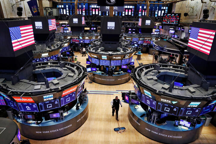 FILE PHOTO: A worker cleans the floor of the New York Stock Exchange (NYSE) , U.S., March 20, 2020.  REUTERS/Lucas Jackson/File Photo