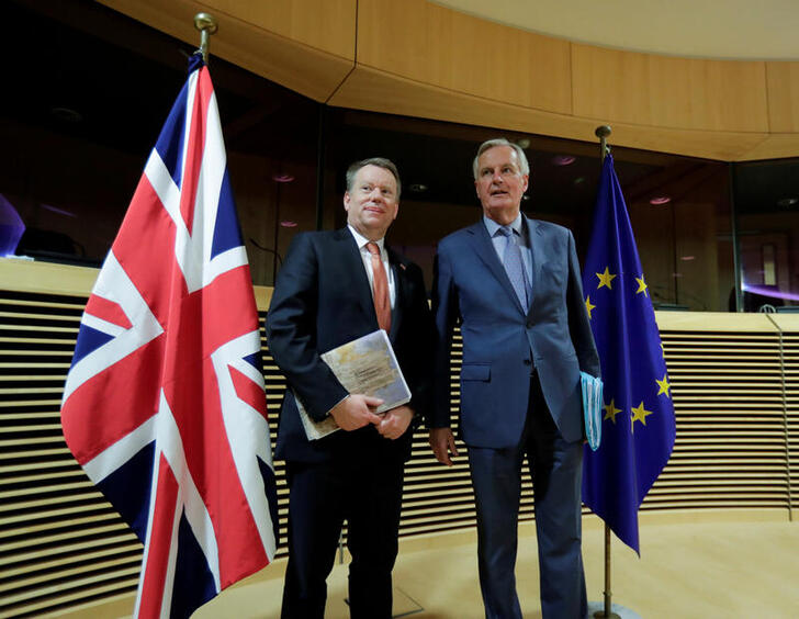 FILE PHOTO: European Union chief Brexit negotiator Michel Barnier and British Prime Minister's Europe adviser David Frost are seen at start of the first round of post -Brexit trade deal talks between the EU and the United Kingdom, in Brussels, Belgium March 2, 2020. Oliver Hoslet/Pool via REUTERS/File Photo