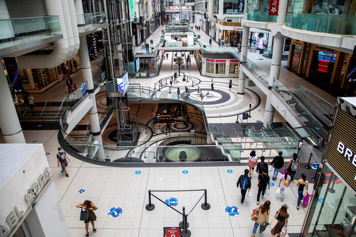 FILE PHOTO: People walk in the Eaton Centre shopping mall, as the provincial phase 2 of reopening from the coronavirus disease (COVID-19) restrictions begins in Toronto, Ontario, Canada June 24, 2020. REUTERS/Carlos Osorio/File Photo