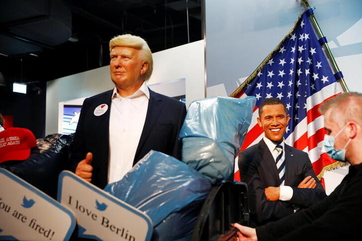 A wax figure depicting U.S. President Donald Trump is put into a dumpster next to a wax figure of former U.S. President Barack Obama at Madame Tussauds in Berlin, Germany, October 30, 2020. REUTERS/Michele Tantussi