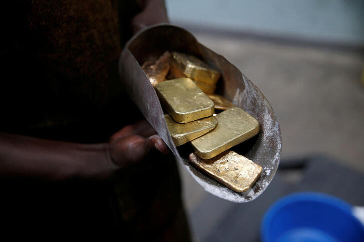 FILE PHOTO: An employee holds gold bars before the refining process at AGR (African Gold Refinery) in Entebbe, Uganda, October 4, 2018. REUTERS/Baz Ratner/File Photo