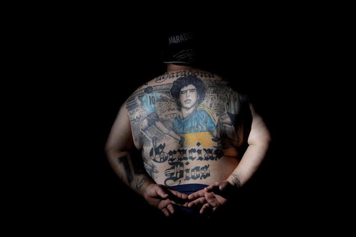 Guillermo Rodriguez, a devoted Diego Maradona fan who has images of Maradona tattooed on his back and who owns a pizza shop called 