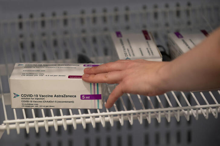 FILE PHOTO: Boxes of the Oxford/AstraZeneca COVID-19 vaccine are pictured in a refrigerator at a NHS mass coronavirus vaccination centre at Robertson House in Stevenage, Hertfordshire, Britain January 11, 2021. Joe Giddens/Pool via REUTERS/File Photo