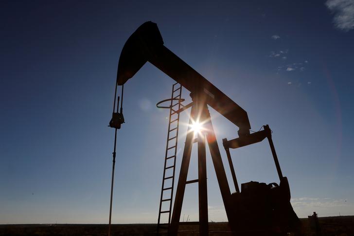 The sun is seen behind a crude oil pump jack in the Permian Basin in Loving County, Texas, U.S., November 22, 2019. Picture taken November 22, 2019.  REUTERS/Angus Mordant