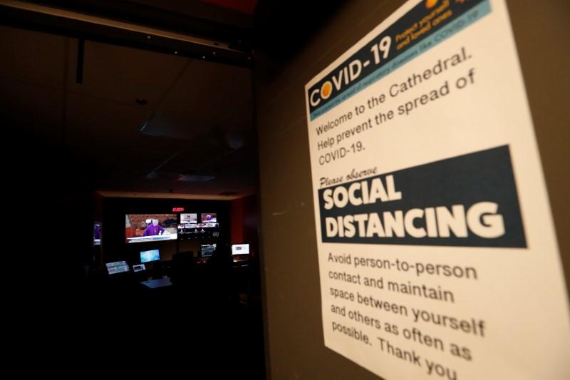 A sign advices about social distancing outside the control room as Archbishop of Los Angeles Jose H. Gomez celebrates Sunday mass via livestream at the Cathedral of Our Lady of the Angels after California's governor Gavin Newsom issued an unprecedented statewide 