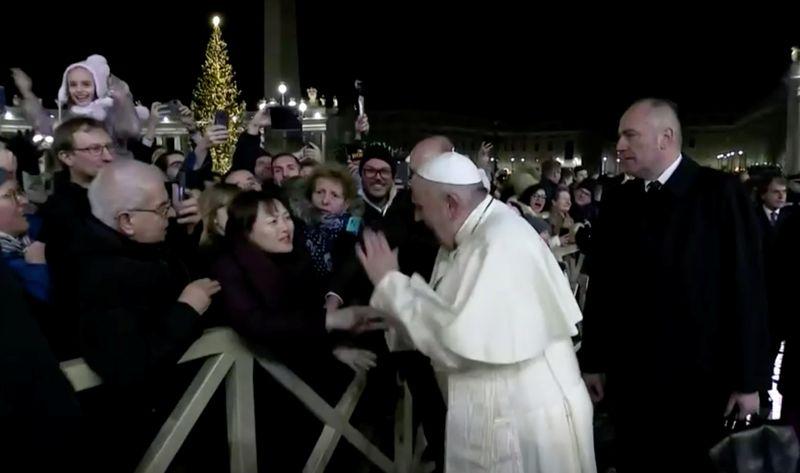 Pope Francis slaps the hand of a woman who grabbed him, at Saint Peter's Square at the Vatican in this still image taken from a video, December 31, 2019. Vatican Media/Handout via REUTERS THIS IMAGE HAS BEEN SUPPLIED BY A THIRD PARTY. - RC2K6E9IAS56