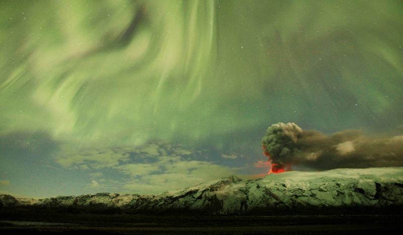 The Northern Lights are seen above the ash plume of a volcano in Eyjafjallajokull, Iceland, April 22, 2010. Picture taken April 22, 2010. REUTERS/Lucas Jackson/File Photo SEARCH 