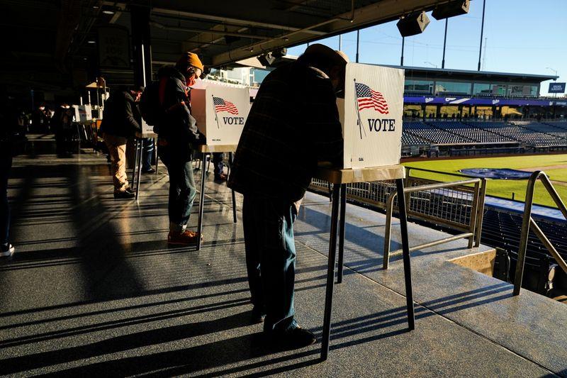 Voters fill out their ballots during early voting at ONEOK Field in Tulsa, Oklahoma, U.S., October 30, 2020. REUTERS/Nick Oxford 