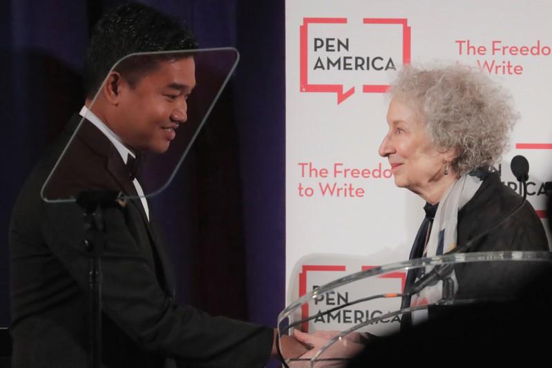 Author Margaret Atwood presents an award to Thura Aung (R) on behalf of detained Reuters journalists Kyaw Soe Oo and Wa Lone at the PEN America Literary Gala in New York, U.S., May 22, 2018. REUTERS/Lucas