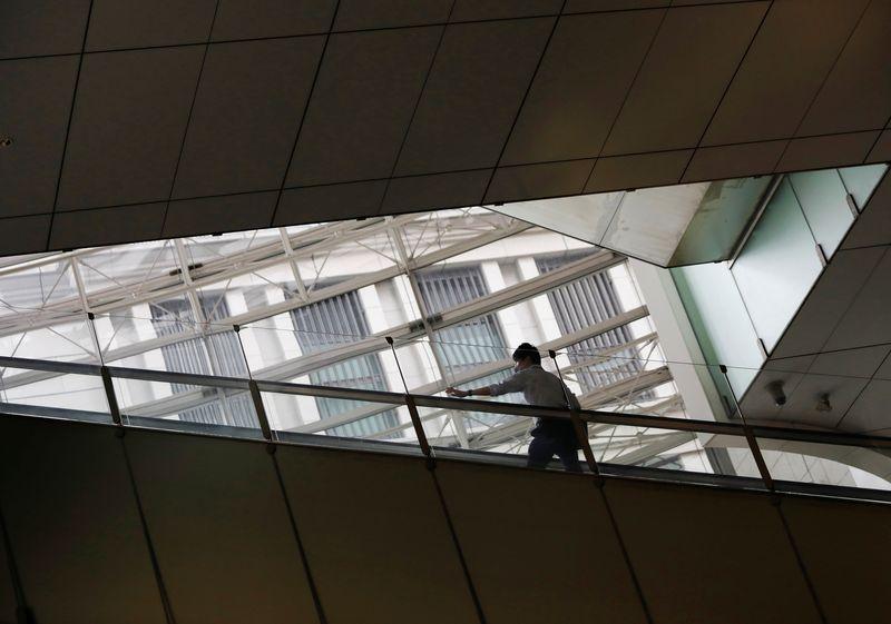 A man wearing a protective face mask is seen inside an office building, amid the coronavirus disease (COVID-19) outbreak, in Tokyo, Japan September 29, 2020. REUTERS/Issei Kato