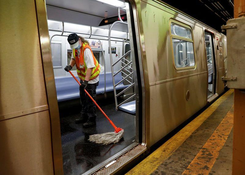 A Metropolitan Transportation Authority (MTA) worker cleans a subway car during the morning commute, as phase one of reopening after lockdown begins, during the outbreak of the coronavirus disease (COVID-19) in New York City, New York, U.S., June 8, 2020. REUTERS/Brendan McDermid