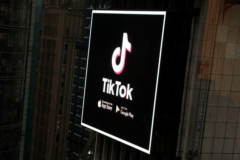 The TikTok logo is seen on a screen over Times Square in New York City, U.S., March 6, 2020. REUTERS/Andrew Kelly 