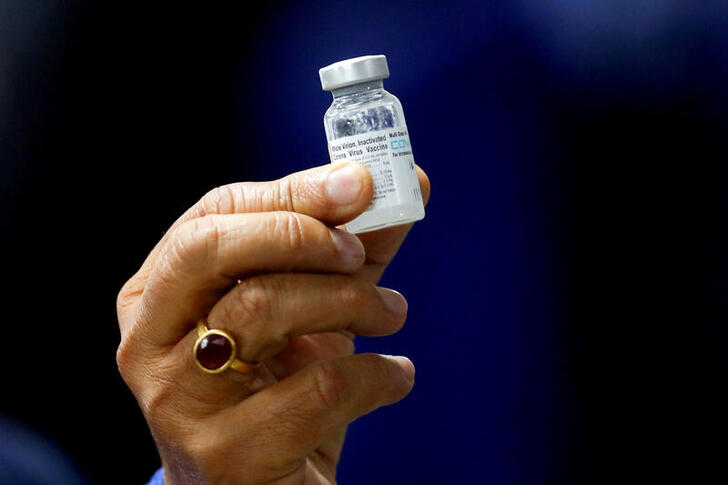 FILE PHOTO: Indian Health Minister Harsh Vardhan holds a dose of Bharat Biotech's COVID-19 vaccine called COVAXIN, during a vaccination campaign at All India Institute of Medical Sciences (AIIMS) hospital in New Delhi, India, January 16, 2021. REUTERS/Adnan Abidi//File Photo