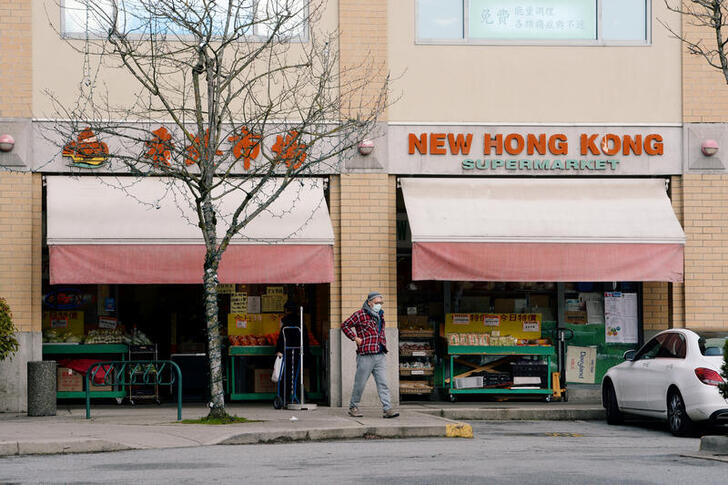 FILE PHOTO: A man walks past New Hong Kong Supermarket in Richmond, British Columbia, Canada January 26, 2021. Picture taken January 26, 2021.  REUTERS/Jennifer Gauthier/File Photo