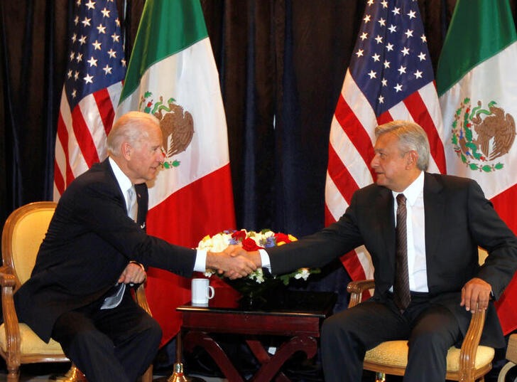 FILE PHOTO: Then-U.S. vice president Joe Biden (L) shakes hands with Andres Manuel Lopez Obrador, then candidate for president of Mexico, in Mexico City, March 5, 2012. REUTERS/Tomas Bravo/File Photo