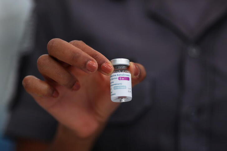 A police officer holds a vial of AstraZeneca's coronavirus disease (COVID-19) vaccine on the first day of state government vaccination for police officers, at Barro Branco Military Police Academy in Sao Paulo, Brazil April 5, 2021. REUTERS/Amanda Perobelli