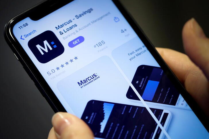 FILE PHOTO: A woman looks at Marcus, a new savings and loans app recently launched by Goldman Sachs in New York, U.S., January 10, 2020. REUTERS/Mike Segar/File Photo