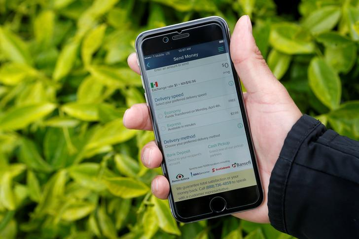 Noe Sanchez shows off the Remitly app that he uses to send money to his family in Mexico in this photo taken in San Francisco, California March 30, 2016.  REUTERS/Beck Diefenbach