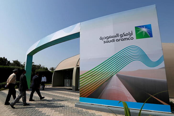 FILE PHOTO: The logo of Aramco is seen as security personnel walk before the start of a press conference by Aramco at the Plaza Conference Center in Dhahran, Saudi Arabia November 3, 2019. REUTERS/Hamad I Mohammed/File Photo