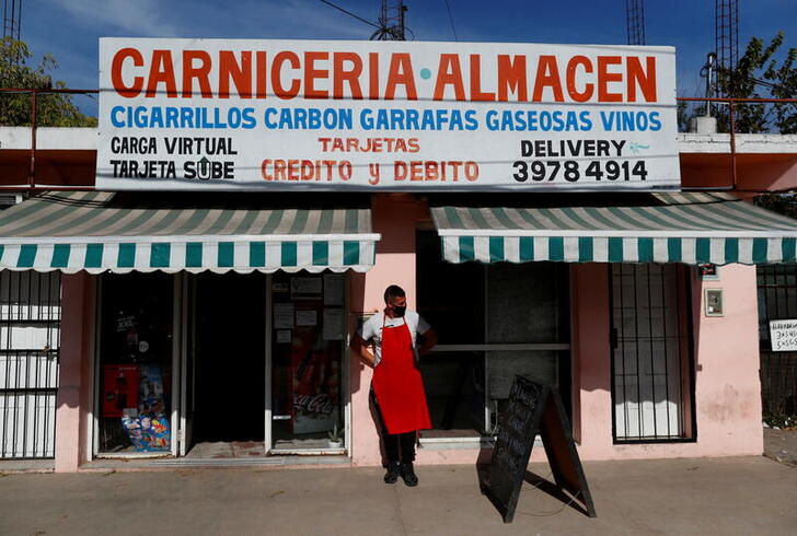 FILE PHOTO: Butcher Pablo Alberto Monzon waits for costumers outside his shop, in General Pacheco, on the outskirts of Buenos Aires, Argentina May 19, 2021. Picture taken May 19, 2021.  REUTERS/Agustin Marcarian/File Photo