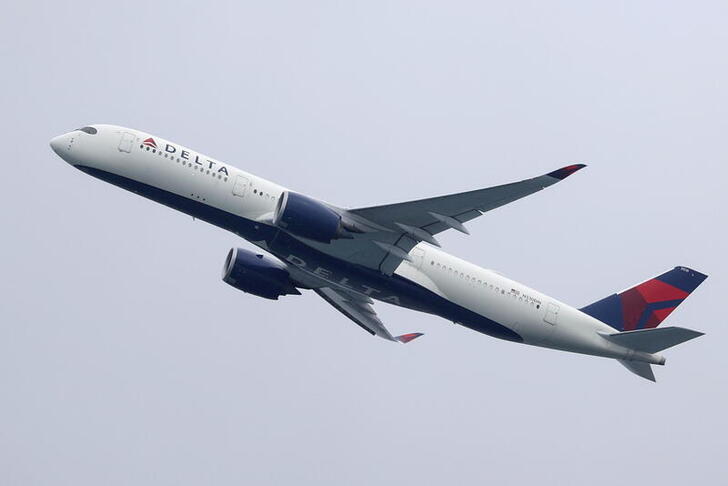 FILE PHOTO: A Delta Air Lines Airbus A350-900 plane takes off from Sydney Airport in Sydney, Australia, October 28, 2020.  REUTERS/Loren Elliott/File Photo