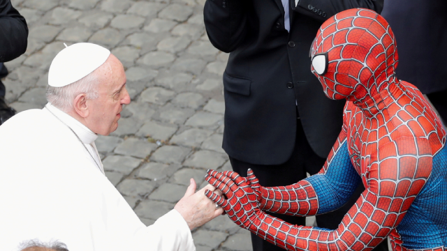 Pope Francis greets a person dressed as Spider-Man, at the Vatican