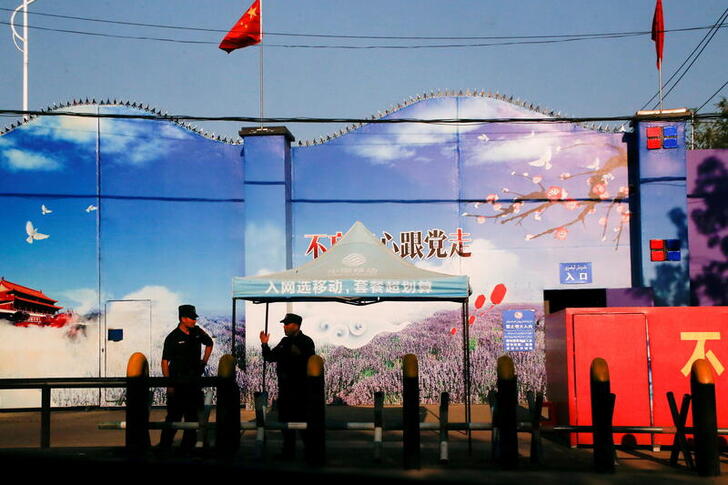 FILE PHOTO: Security guards stand at the gates of what is officially known as a vocational skills education center in Huocheng County in Xinjiang Uighur Autonomous Region, China September 3, 2018.REUTERS/Thomas Peter/File Photo