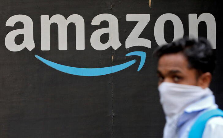 FILE PHOTO: A man walks past an Amazon logo outside the company's collection point in Mumbai, India, March 19, 2021. REUTERS/Francis Mascarenhas/File Photo