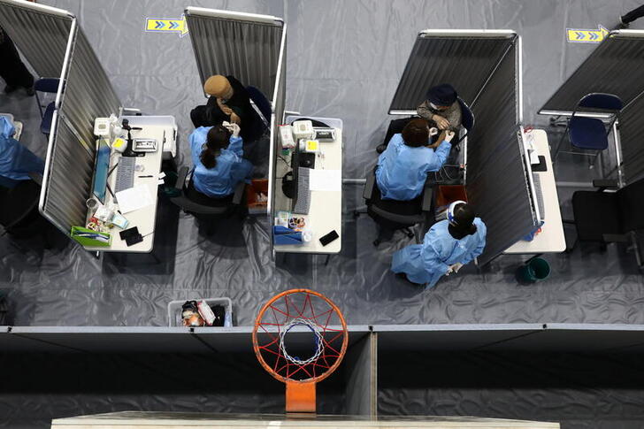 South Korean senior citizens receive their first dose of the Pfizer-BioNTech coronavirus disease (COVID-19) vaccine at a vaccination centre in Seoul, South Korea April 1, 2021. Chung Sung-Jun/Pool via REUTERS