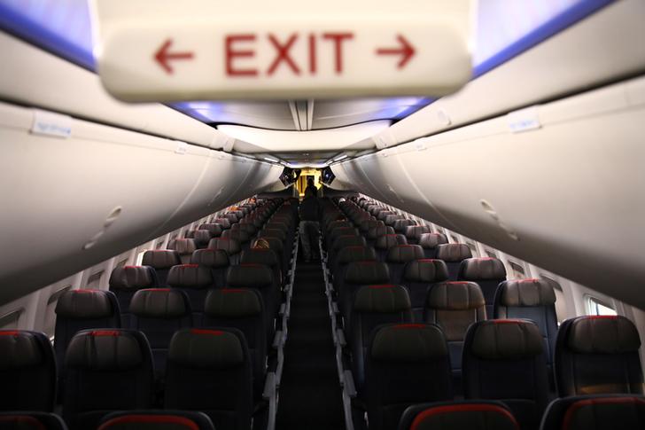 Rows of empty seats of an American Airline flight are seen, as coronavirus disease (COVID-19) disruption continues across the global industry, during a flight between Washington D.C. and Miami, in Washington, U.S., March 18, 2020. REUTERS/Carlos Barria