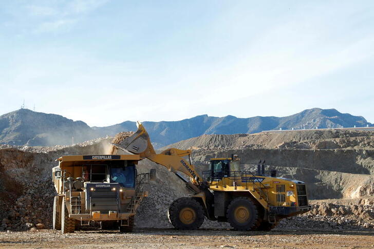 FILE PHOTO: A wheel loader operator fills a truck with ore at the MP Materials rare earth mine in Mountain Pass, California, U.S. January 30, 2020. Picture taken January 30, 2020. REUTERS/Steve Marcus/File Photo