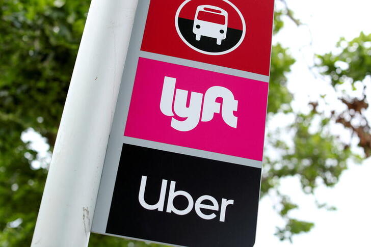 FILE PHOTO: A sign marks a rendezvous location for Lyft and Uber users at San Diego State University in San Diego, California, U.S., May 13, 2020.      REUTERS/Mike Blake/File Photo