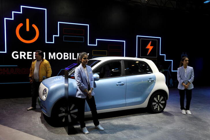 FILE PHOTO: Models pose next to Great Wall Motors (GWM) GWM R1 electric car at its pavilion at the India Auto Expo 2020 in Greater Noida, India, February 5, 2020. REUTERS/Anushree Fadnavis/File Photo