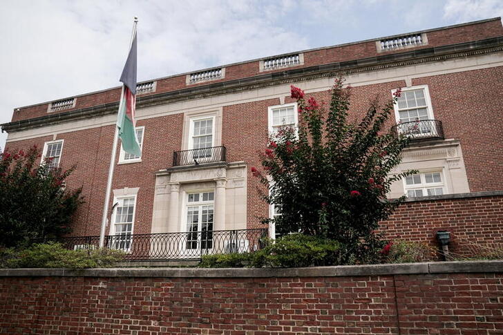 FILE PHOTO: An Afghan flag flutters outside the Afghan embassy in Washington, U.S., August 15, 2021 on the day Taliban insurgents entered Afghanistan's capital Kabul.  REUTERS/Ken Cedeno/File Photo