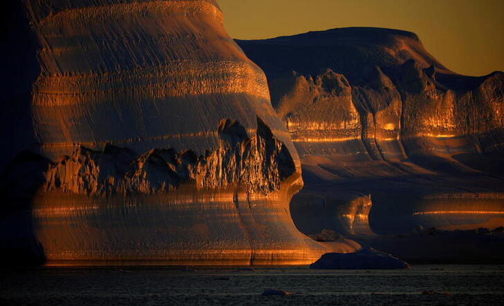FILE PHOTO: Icebergs are seen at the at the mouth of the Jakobshavns ice fjord during sunset near Ilulissat, Greenland, September 16, 2021. REUTERS/Hannibal Hanschke/File Photo