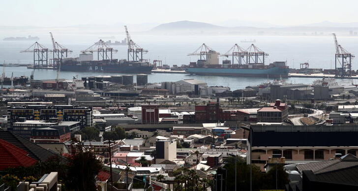 FILE PHOTO: Container ships wait to load and offload goods in port during a 21-day nationwide lockdown aimed at limiting the spread of coronavirus disease (COVID-19) in  Cape Town, South Africa, April 17, 2020. REUTERS/Mike Hutchings/File Photo