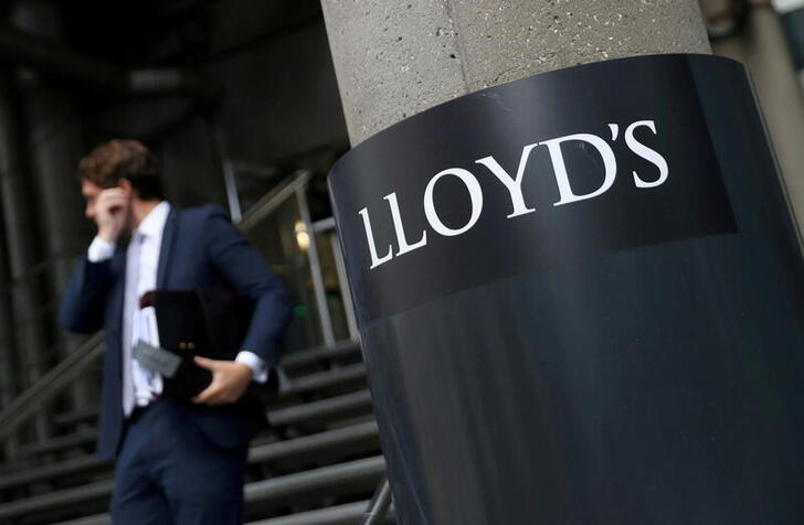 FILE PHOTO: A man walks out of Lloyd's of London's headquarters in the City of London, Britain, July 31, 2018. REUTERS/Simon Dawson//File Photo