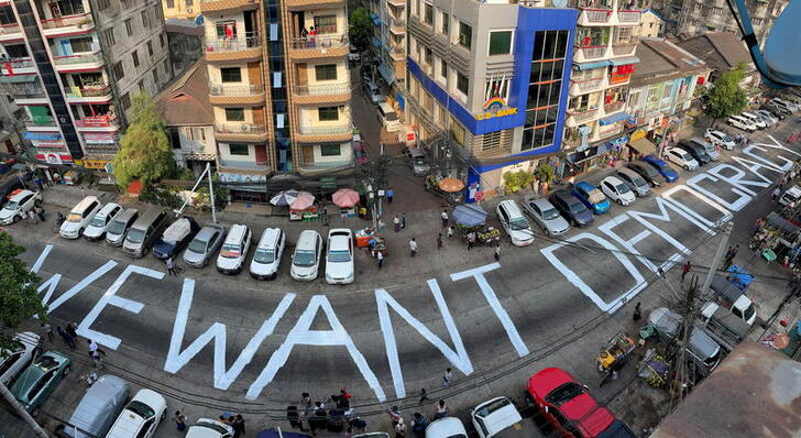 FILE PHOTO: A slogan is written on a street as a protest after the coup in Yangon, Myanmar February 21, 2021. Picture taken with iPhone panoramic mode. REUTERS/Stringer/File Photo