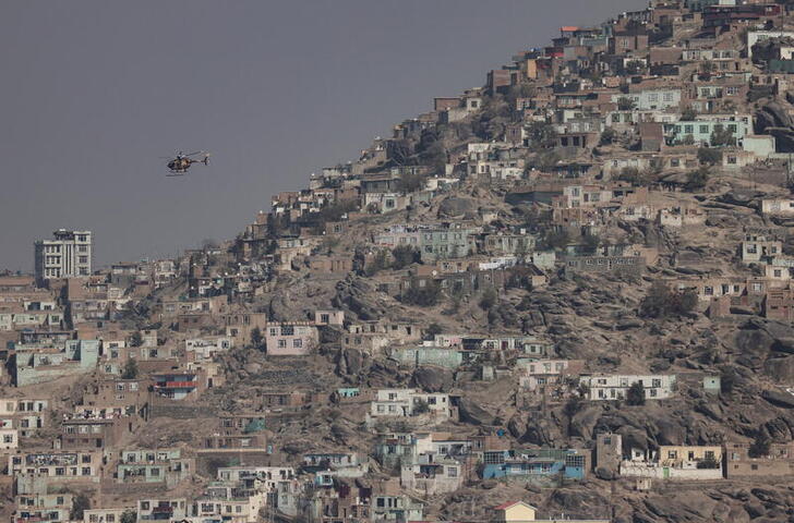 FILE PHOTO: A military helicopter is pictured flying over Kabul, Afghanistan November 4, 2021.REUTERS/Zohra Bensemra/File Photo