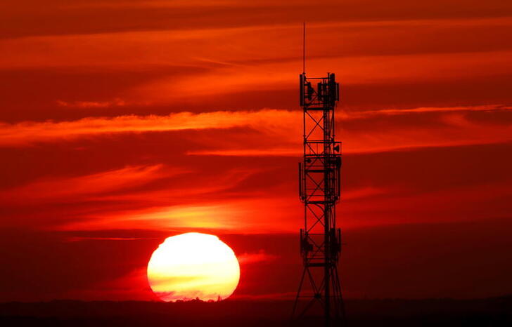 FILE PHOTO: The sun sets behind transmitting antennas on a mobile-phone network relay mast in Vertou near Nantes France, November 10, 2021. REUTERS/Stephane Mahe/File Photo