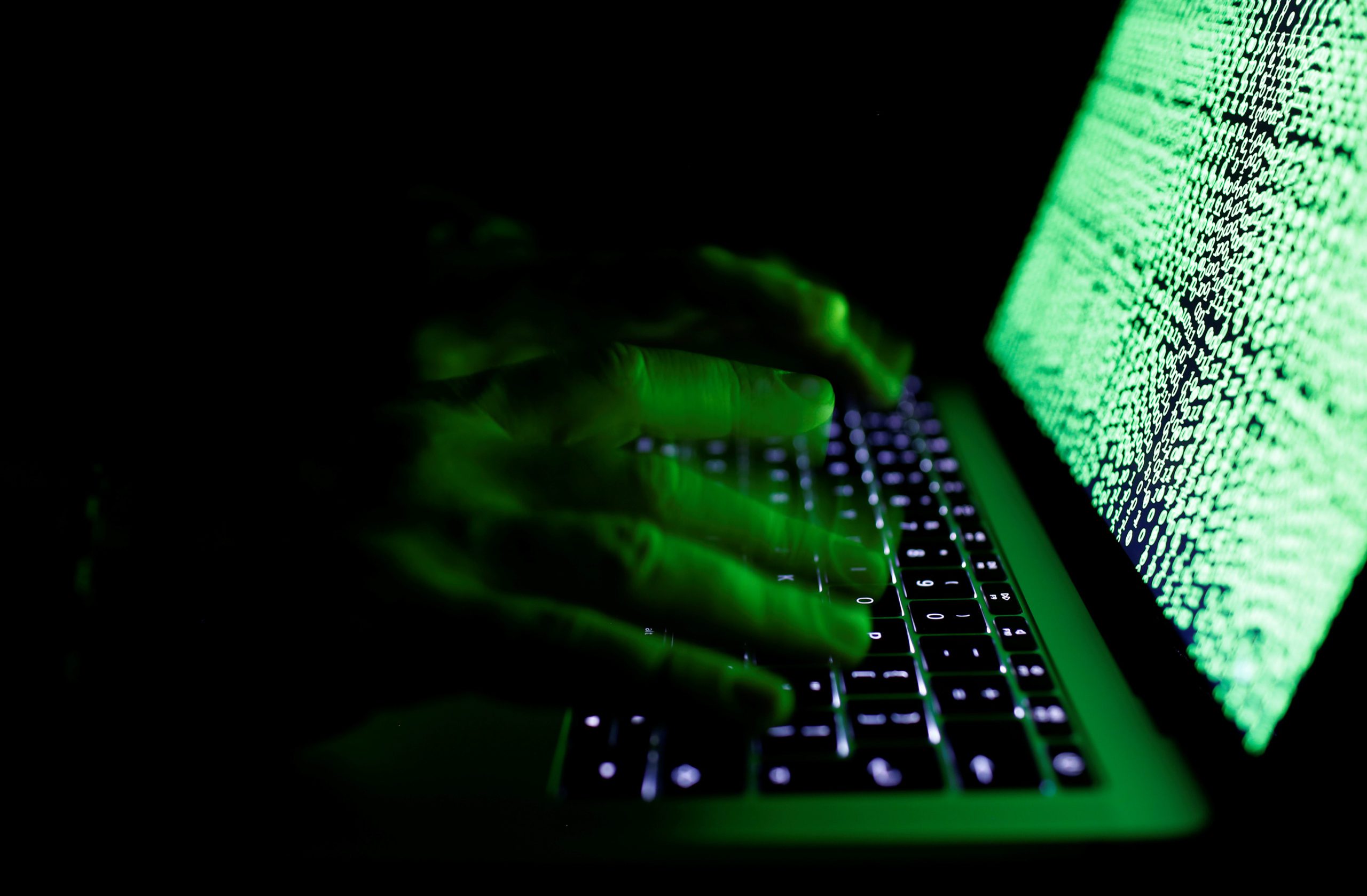 A man types on a computer keyboard in front of the displayed cyber code in this illustration picture taken on March 1,  2017.REUTERS/Kacper Pempel/Illustration - RC13A0D7C530