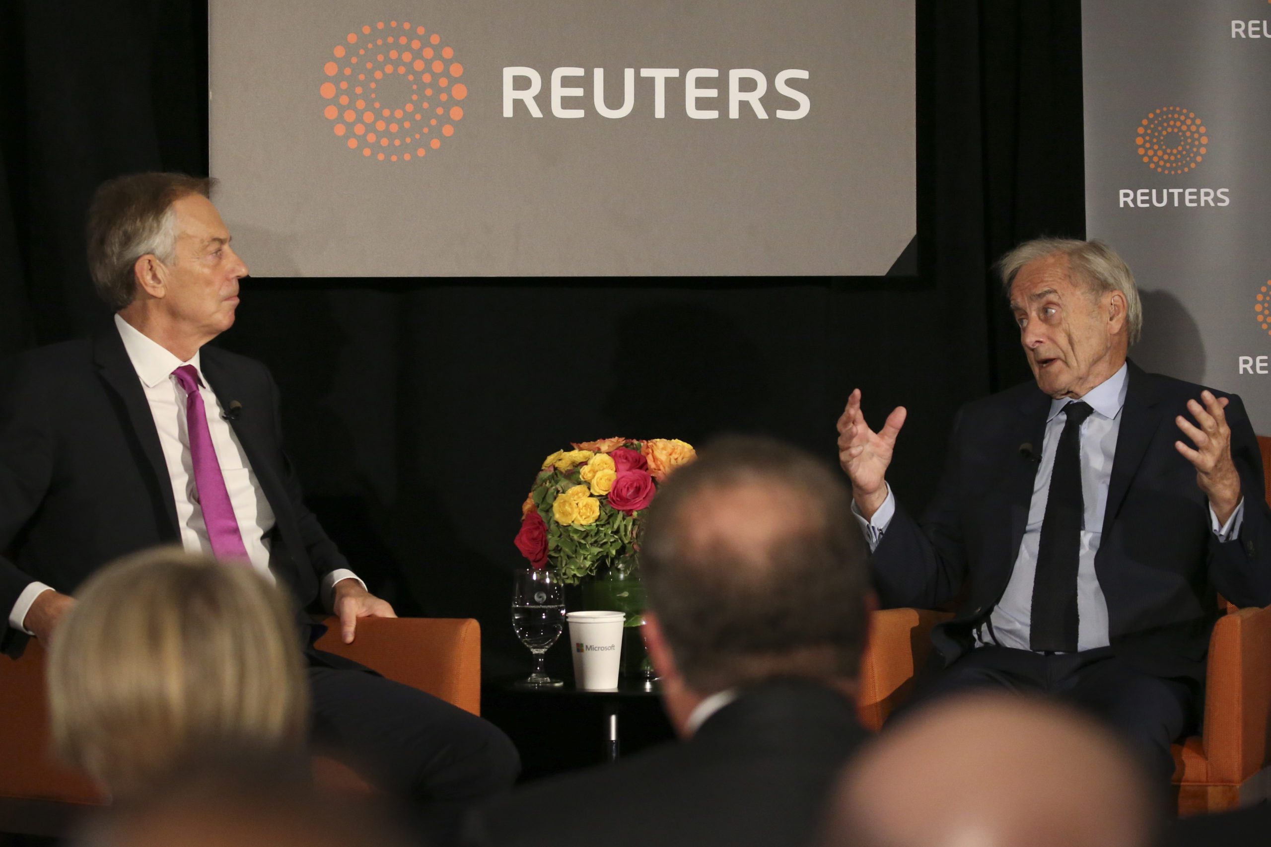 Former British Prime Minister Tony Blair looks on as Reuters Editor-at-Large Sir Harold Evans (R) moderates a Reuters Newsmaker conversation 