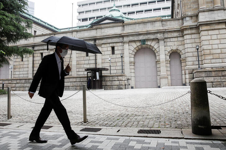FILE PHOTO: A man wearing a protective mask walks past the headquarters of Bank of Japan amid the coronavirus disease (COVID-19) outbreak in Tokyo, Japan, May 22, 2020.REUTERS/Kim Kyung-Hoon/File Photo