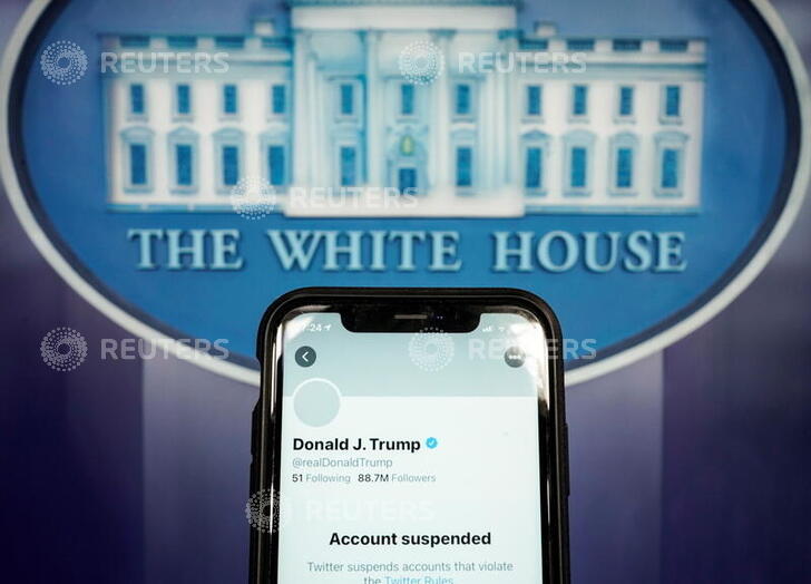 A photo illustration shows the suspended Twitter account of U.S. President Donald Trump on a smartphone at the White House briefing room in Washington, U.S., January 8, 2021.  REUTERS/Joshua Roberts/Illustration