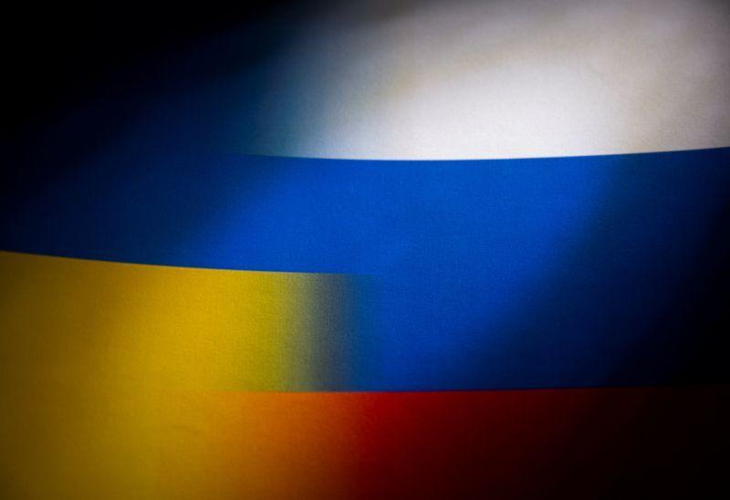 FILE PHOTO: Russia's and Ukraine's flags are seen printed on paper in this illustration taken January 27, 2022. REUTERS/Dado Ruvic/Illustration