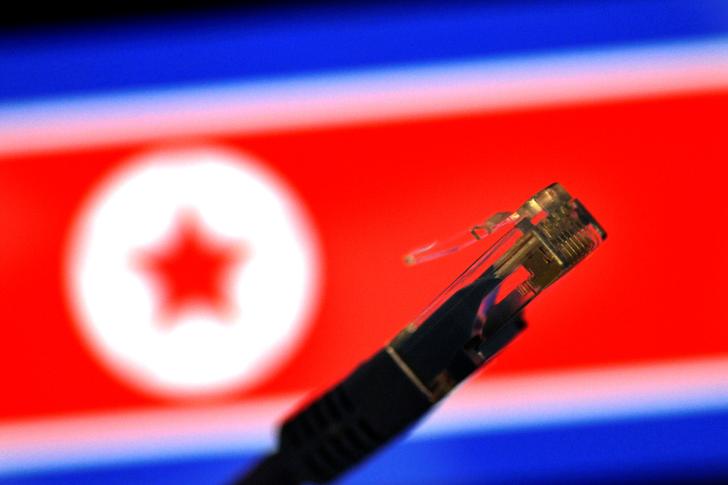 A network LAN cable is seen against a North Korean flag in this illustration photo November 1, 2017.   REUTERS/Thomas White/Illustration